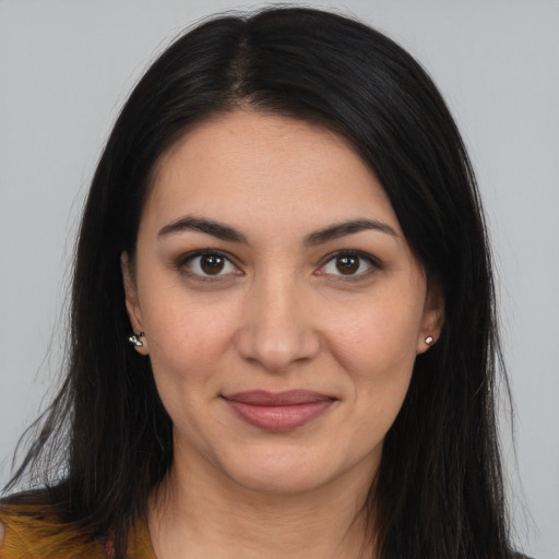 Joyful latino young-adult female with long  brown hair and brown eyes