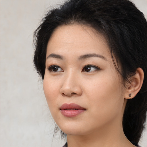 Neutral asian young-adult female with medium  brown hair and brown eyes