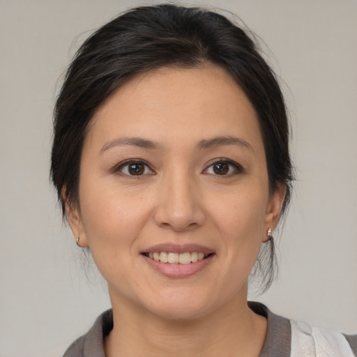 Joyful white young-adult female with medium  brown hair and brown eyes