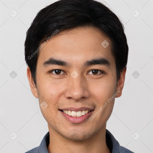 Joyful white young-adult male with short  black hair and brown eyes