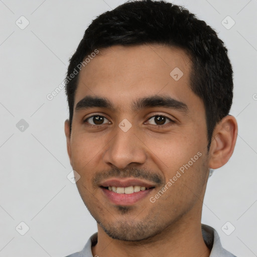 Joyful latino young-adult male with short  black hair and brown eyes