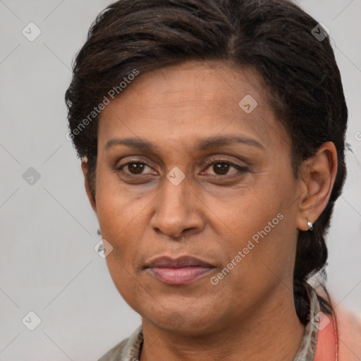 Joyful latino adult female with short  brown hair and brown eyes