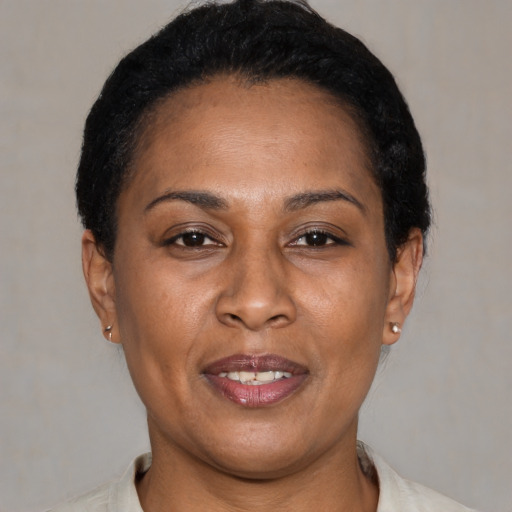 Joyful latino adult female with short  black hair and brown eyes