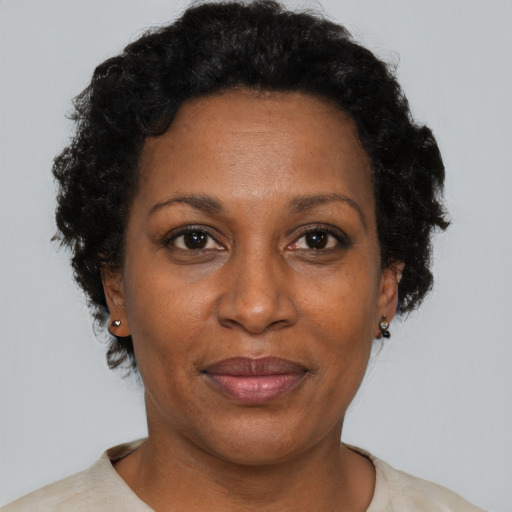 Joyful black adult female with short  brown hair and brown eyes