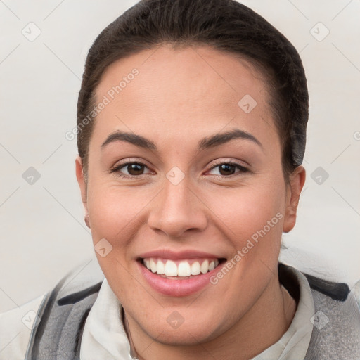 Joyful white young-adult female with short  brown hair and brown eyes