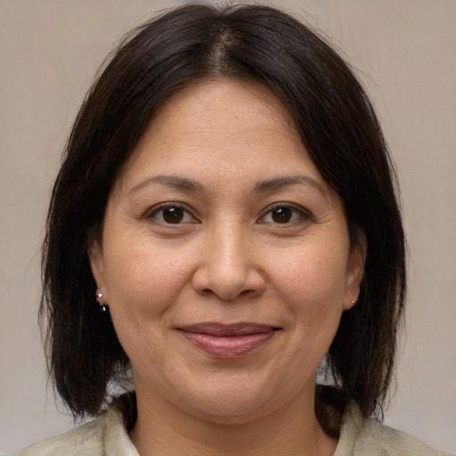 Joyful white adult female with medium  brown hair and brown eyes