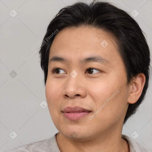 Joyful asian young-adult male with short  brown hair and brown eyes