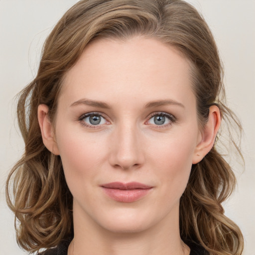 Joyful white young-adult female with medium  brown hair and blue eyes