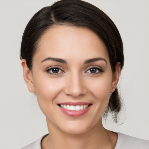 Joyful white young-adult female with medium  brown hair and brown eyes