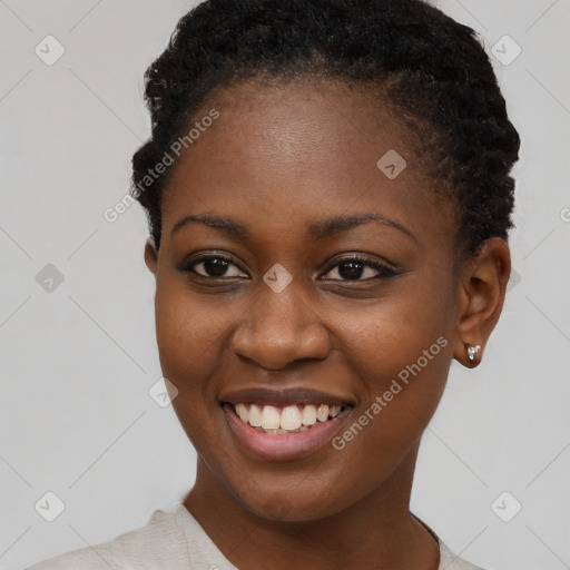 Joyful black young-adult female with short  brown hair and brown eyes