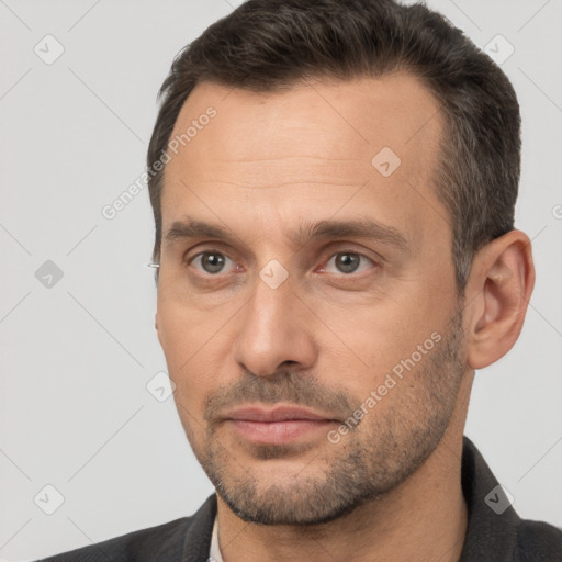 Joyful white adult male with short  brown hair and brown eyes