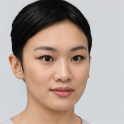 Joyful asian young-adult female with short  black hair and brown eyes