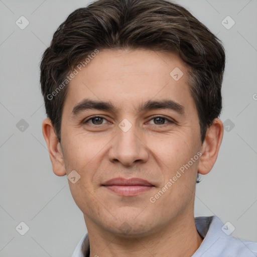 Joyful white young-adult male with short  brown hair and brown eyes