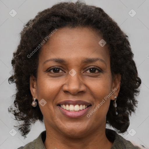 Joyful black adult female with short  brown hair and brown eyes