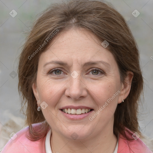 Joyful white adult female with medium  brown hair and grey eyes