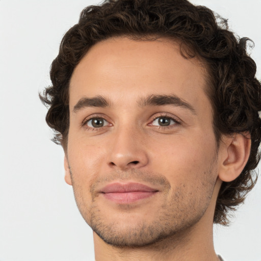 Joyful white young-adult male with short  brown hair and green eyes