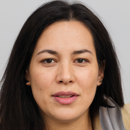 Joyful asian adult female with long  brown hair and brown eyes