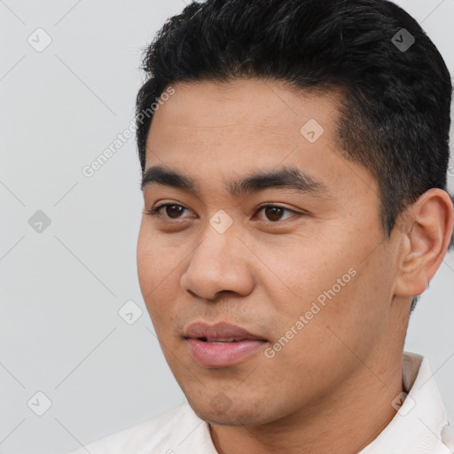 Joyful asian young-adult male with short  black hair and brown eyes