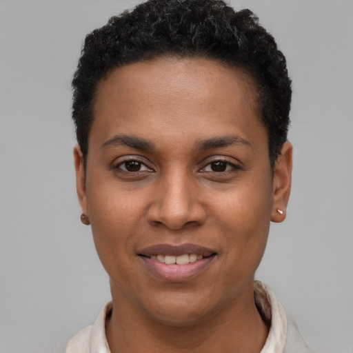 Joyful black young-adult female with short  black hair and brown eyes