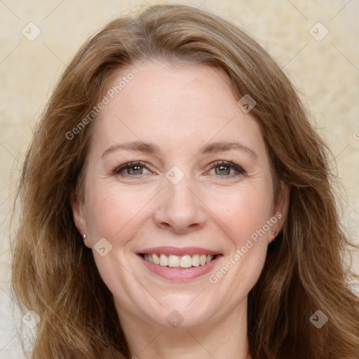 Joyful white adult female with long  brown hair and brown eyes