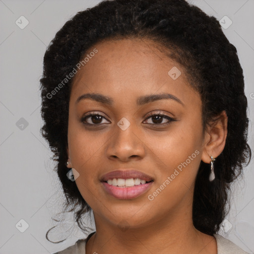 Joyful black young-adult female with long  brown hair and brown eyes