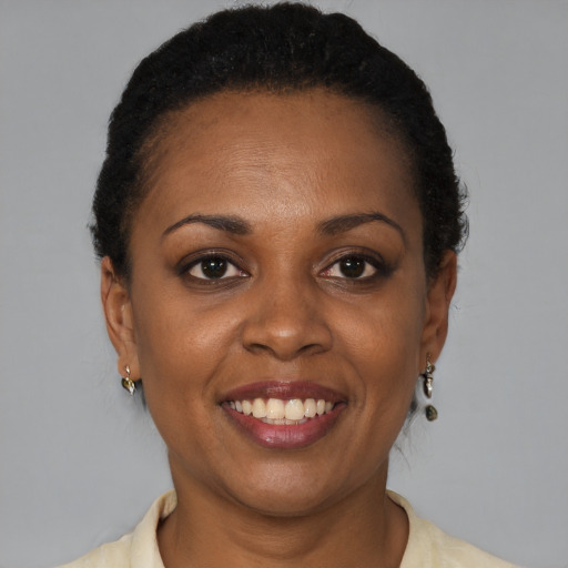 Joyful black adult female with short  brown hair and brown eyes