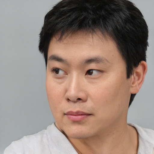 Neutral asian young-adult male with short  black hair and brown eyes