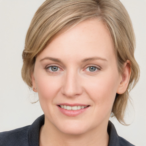 Joyful white young-adult female with medium  brown hair and blue eyes