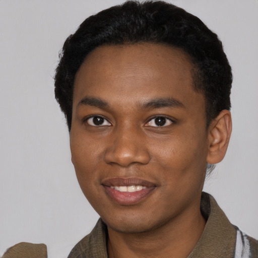 Joyful black young-adult male with short  black hair and brown eyes