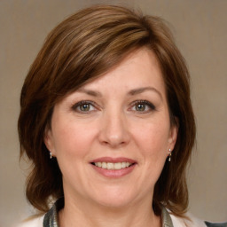 Joyful white adult female with medium  brown hair and grey eyes