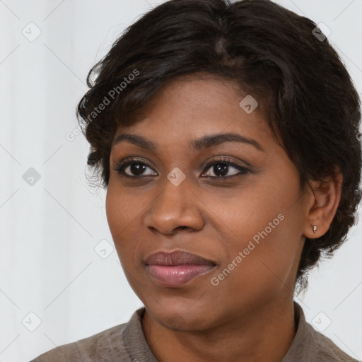 Joyful black young-adult female with medium  brown hair and brown eyes