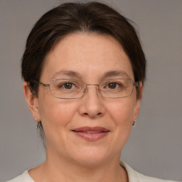 Joyful white adult female with medium  brown hair and brown eyes