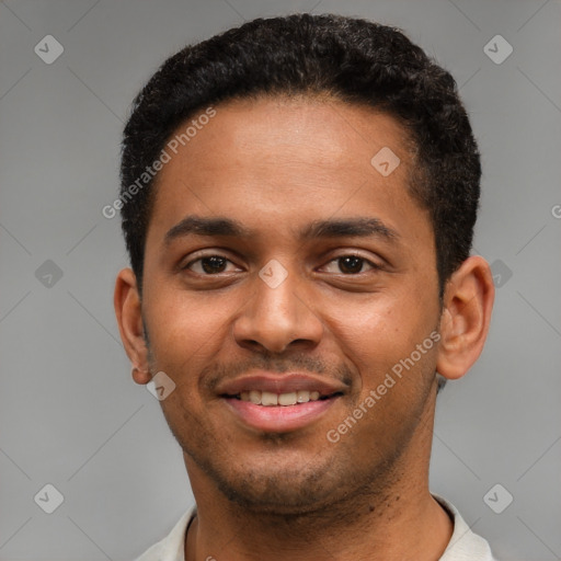 Joyful black young-adult male with short  brown hair and brown eyes