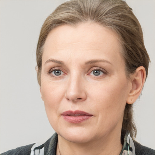 Joyful white adult female with medium  brown hair and grey eyes