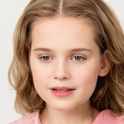 Joyful white child female with long  brown hair and blue eyes