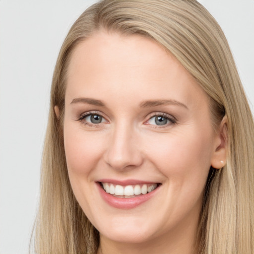 Joyful white young-adult female with long  brown hair and blue eyes