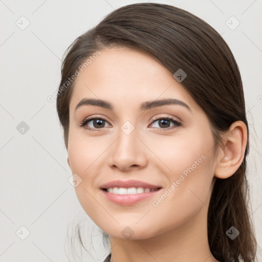 Joyful white young-adult female with long  brown hair and brown eyes