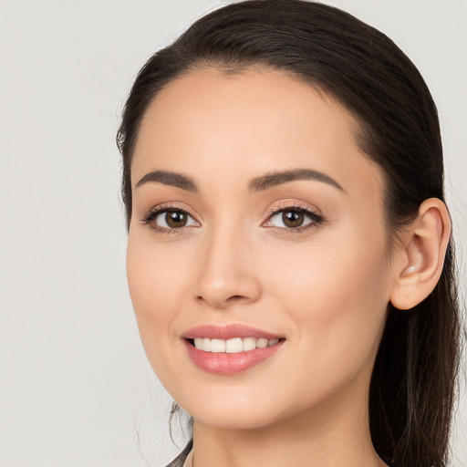 Joyful white young-adult female with long  brown hair and brown eyes