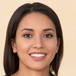 Joyful white young-adult female with long  brown hair and brown eyes