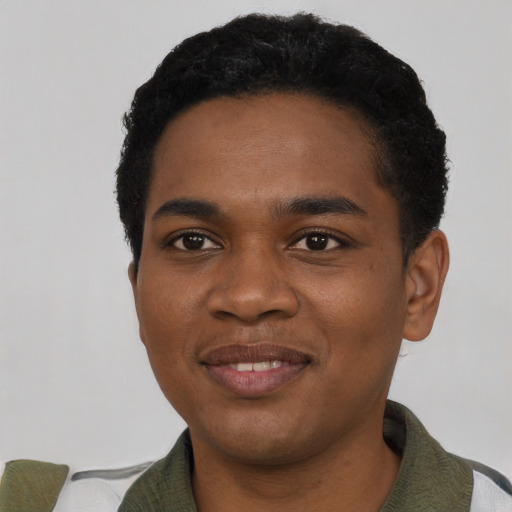 Joyful black young-adult male with short  black hair and brown eyes