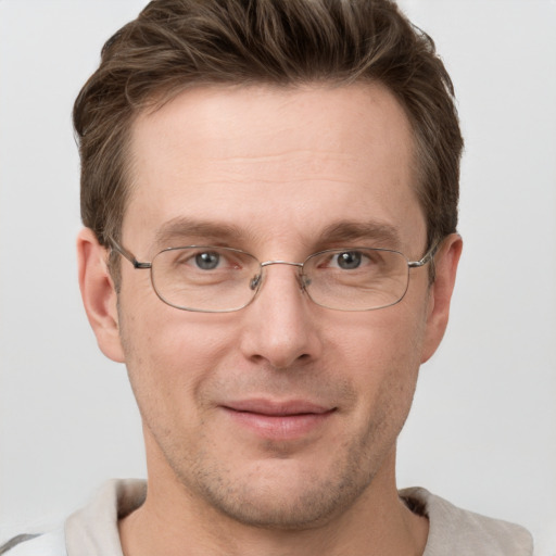 Joyful white adult male with short  brown hair and grey eyes