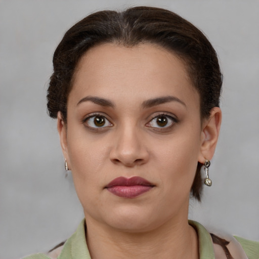 Joyful latino young-adult female with short  brown hair and brown eyes