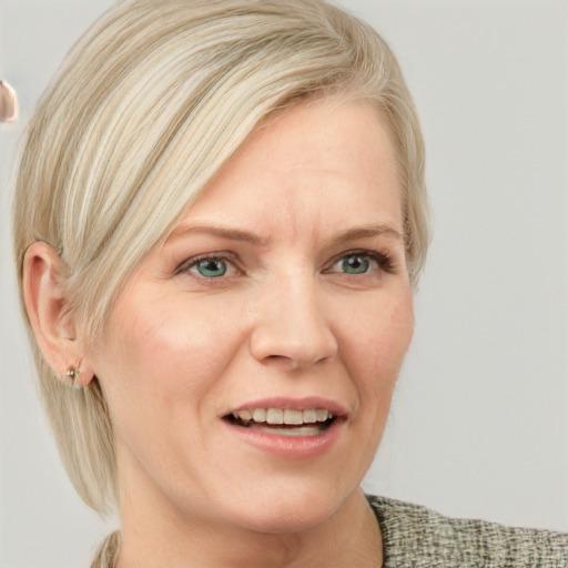 Joyful white adult female with medium  blond hair and blue eyes