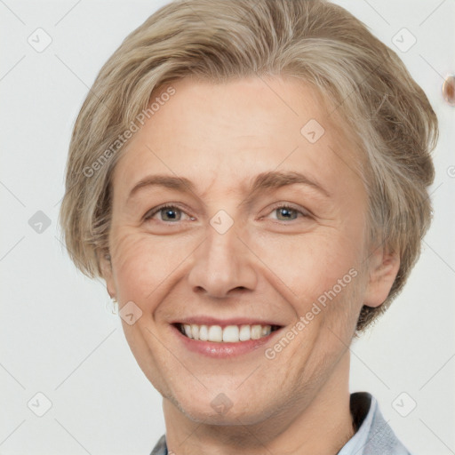 Joyful white adult female with short  brown hair and grey eyes