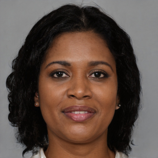 Joyful black young-adult female with medium  black hair and brown eyes