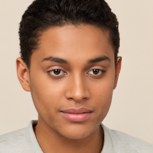 Joyful latino young-adult male with short  brown hair and brown eyes