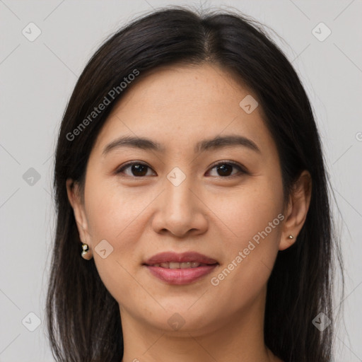 Joyful asian young-adult female with long  brown hair and brown eyes