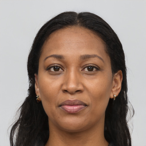 Joyful latino adult female with long  brown hair and brown eyes