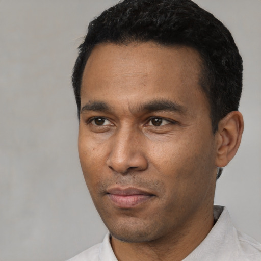 Neutral latino young-adult male with short  black hair and brown eyes