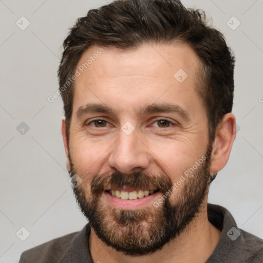 Joyful white adult male with short  brown hair and brown eyes